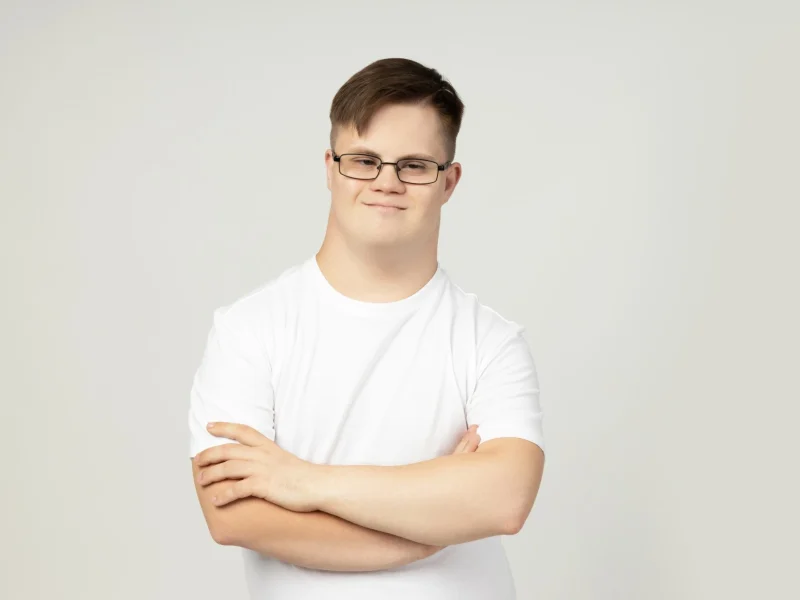 Disabled man with down syndrome smiling at the camera